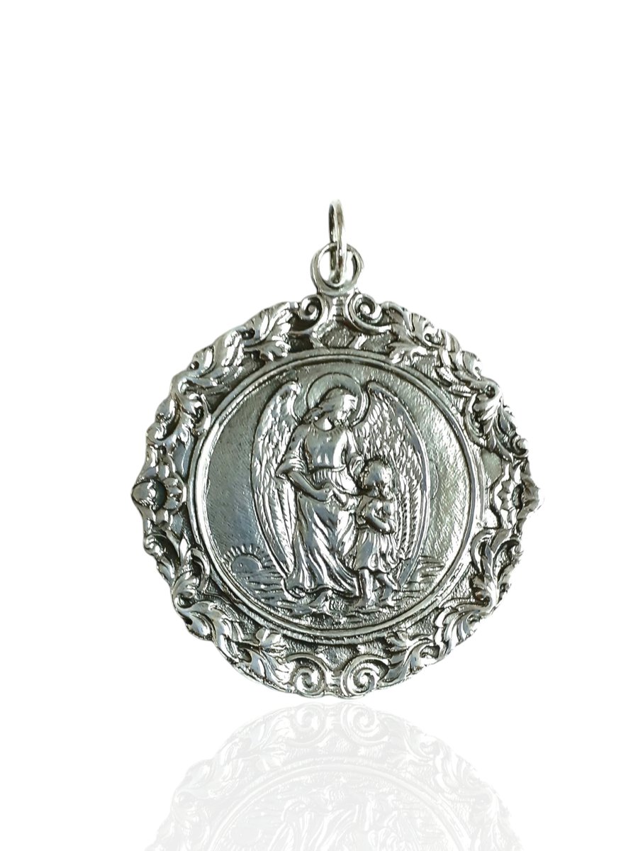 Medalla de cuna en plata de ley con ángel de la guarda pequeña. Plata